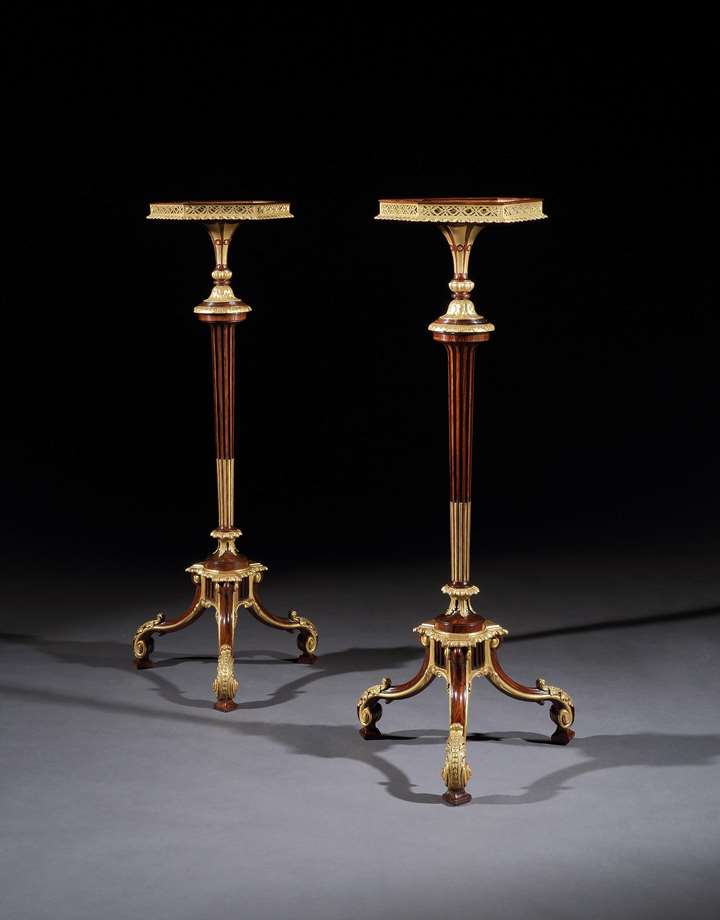 A pair of parcel gilt rosewood torchères